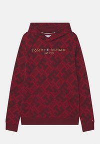 Felpa rossa con cappuccio caratterizzata da un motivo logo tonale, tasca a marsupio e branding "TOMMY HILFIGER" in oro. Polsini e orlo a coste. Tessuto morbido.