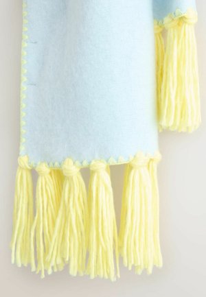 Hele sinine vildist tekk pastelselt kollaste tuttidega. Teki serva ääristab laineline õmblus ning allosas on tekstuuriga tutt.