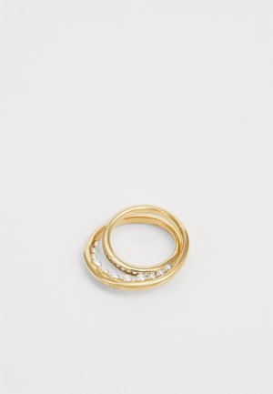 Three intertwined gold rings, one embellished with small pearls and another with tiny clear crystals, on a white background.