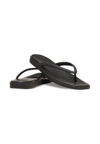 Infradito nere in gomma con plantare testurizzato, sottili cinturini e suola piatta. Presentano un marchio discreto sul lato.