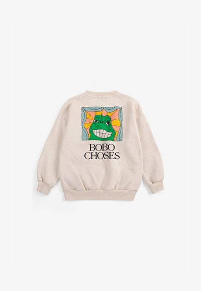 Sweat-shirt beige avec une grenouille dessin animé colorée souriante dans un cadre carré et texte "BOBO CHOSES" sous le design dans le dos.