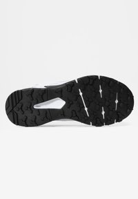Semelle de chaussure avec bande de roulement en caoutchouc noir présentant des motifs hexagonaux et linéaires sur fond blanc, conçue pour l’adhérence et la durabilité.