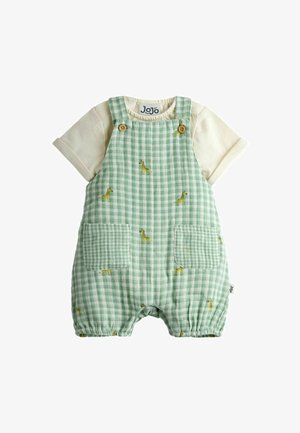 Kortærmet cremefarvet skjorte med grøn gingham-romeper med små gule giraffprint og forlommer, træknap-stropper.