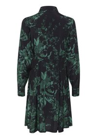 Robe noire ornée d'un motif floral vert, avec un col et des manches longues. Jupe évasée avec des boutons décoratifs aux poignets.