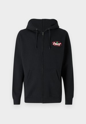 Hoodie zippé noir en tissu doux, muni d'un patch logo à l'avant, d'une capuche avec cordons de serrage et de poches kangourou. Texture lisse, coupe athlétique.