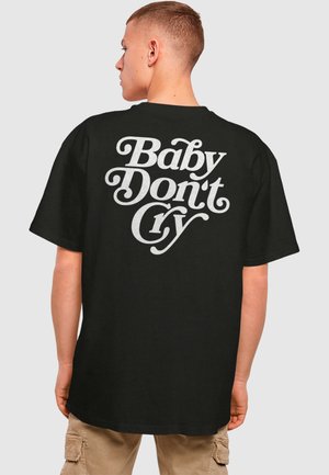 Black cotton t-shirt featuring bold white stylized text on the back that reads "Baby Don't Cry." Short sleeves, relaxed fit.