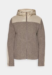 Giacca con cappuccio caratterizzata da un corpo in misto lana marrone e spalle imbottite di colore beige chiaro. Include una cerniera integrale e un tessuto strutturato.