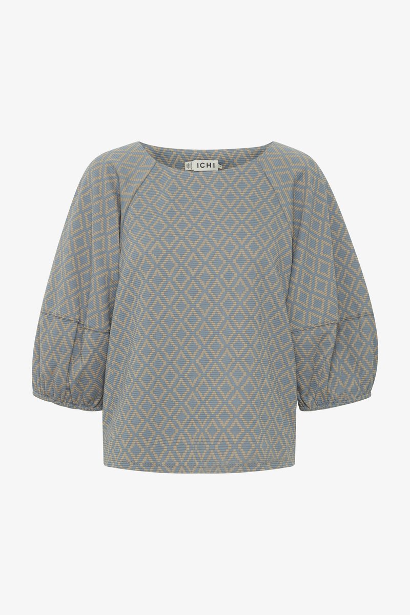 Lichtblauwe top met een diamantpatroon in beige; heeft een ronde hals en pofmouwen, gemaakt van een gestructureerde stof.