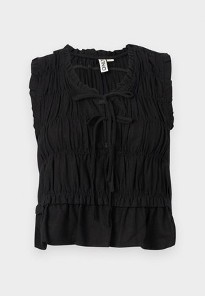 Blouse noire sans manches avec tissu froncé, bords à volants, fermeture nouée à l'avant et ourlet légèrement évasé.