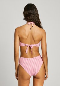 Στριπτη μπικίνι σε ροζ και λευκό, με αποσπώμενο λαιμό και φιόγκο και ψηλόμεσο κάτω μέρος με ελαστικές πλευρές.