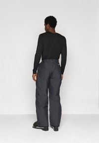 Sooja talvepüksid tumedas hallis värvitoonis, millel on mugav lõige, kõrge vöökoht, küljetaskud ja tugevdatud alumised servad.