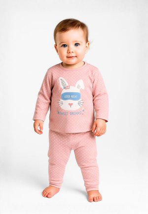 Pink two-piece pajama set featuring long-sleeve top with bunny face graphic, polka dots, and text; soft fabric, elastic waistband on pants.