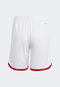 White athletic shorts with a red trim at the hem, elastic waistband, and smooth fabric; features a brand logo near the waistband.