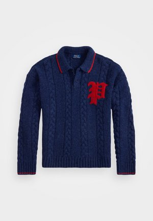 Navy blue cable-knit sweater with collar, red trim, and large red letter "P" patch on left chest.