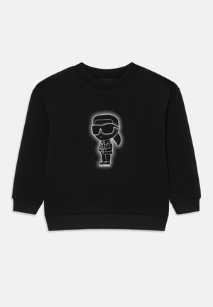 Sweat-shirt noir à col rond, avec un graphique central blanc représentant un personnage en lunettes de soleil et costume. Texture douce, poignets et ourlet côtelés.