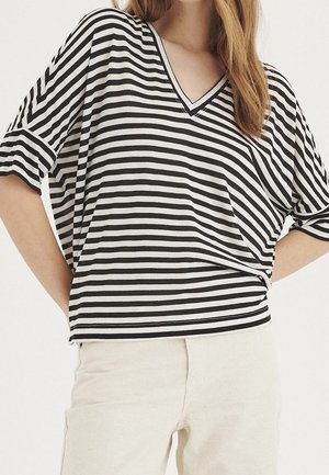 Black and white striped t-shirt with a V-neck and short, rolled sleeves. Soft fabric, relaxed fit, featuring horizontal lines of varying widths.