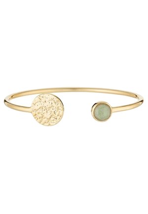 Gold open bangle bracelet with one textured round disc and one smaller round green stone end.