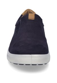 Navy suede slip-on shoes with a tan accent tab, white rubber sole, and textured detailing on the sole for grip.