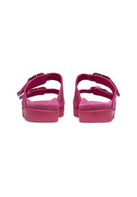 Pink suede sandals with two adjustable straps, flat rubber soles, and metallic buckle accents on the back.