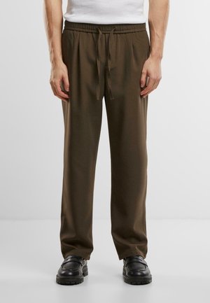 Olive green drawstring pants with a relaxed fit, made from a smooth fabric. Features an elastic waistband and tapered legs.