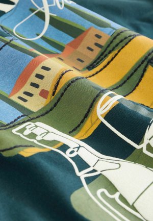 Cotton fabric featuring a colorful landscape print with houses, cypress trees, and stitched outlines in yellow and green on a blue background.