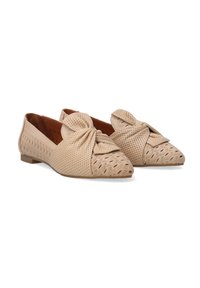 Beige flache Schuhe mit einem geknoteten Design, ausgestattet mit einer perforierten Struktur im Obermaterial und einem gemusterten Detail an der Zehenpartie.