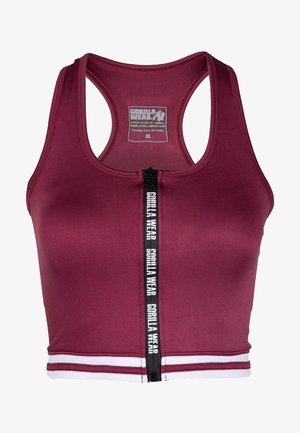 Bordo sporta croptops, kas izgatavots no elastīga auduma, ar priekšējo rāvējslēdzēju un baltām akcenta svītrām ap apakšu. Redzamais logotips.