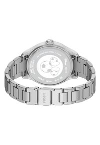 Klocka i rostfritt stål med länkarmband och rund klockkåpa. Baksidan har ett ingraverat mönster och varumärke. Vattentålig upp till 5 ATM.