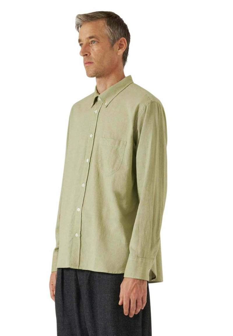 Camicia a maniche lunghe verde chiaro con colletto abbottonato, taschino sul petto e texture liscia. Progettata con una vestibilità comoda e orlo dritto.