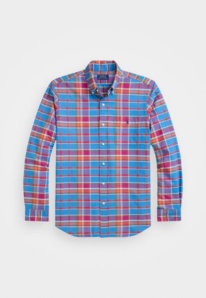 Chemise à manches longues boutonnée avec motif à carreaux multicolores en bleu, rouge, orange et violet, avec poche poitrine et col boutonné.