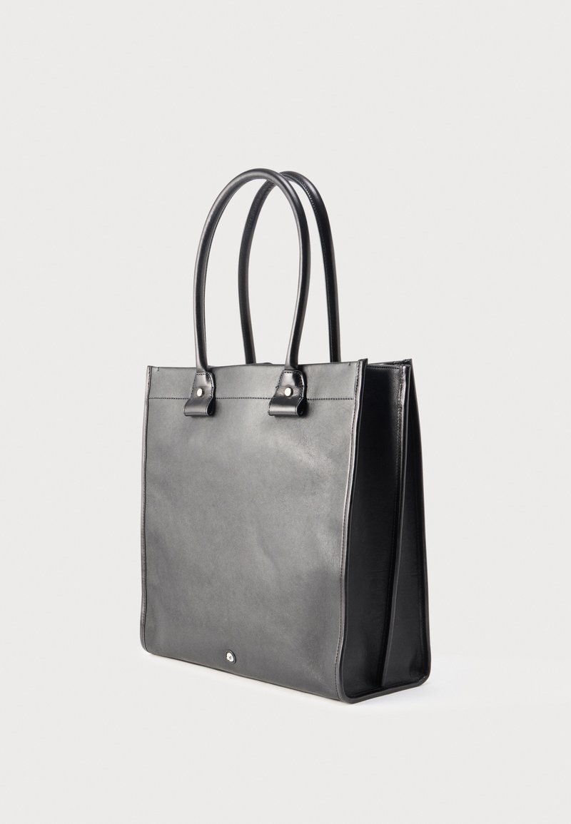 Black leather tote bag with structured shape, two handles, and snap closure. Smooth texture, minimalistic design, and no visible patterns.