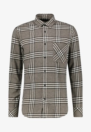 Chemise à manches longues à carreaux marron, noir et blanc, avec une poche poitrine arborant un motif à carreaux en diagonale.