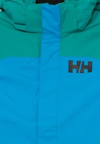 Färgglad vinterjacka med en design i turkos och grön, med en slät yta och en framträdande svart "H/H"-logotyp på framsidan.