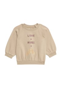 Felpa beige con maniche lunghe a sbuffo, polsini a coste e un orlo aderente. Presenta il testo "AMORE + ABBRACCI" e un'illustrazione di un croissant sorridente.