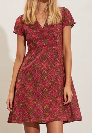 Kort roze jurk met een diepe V-hals en korte mouwen, met een kleurrijk, ingewikkeld geometrisch patroon en een uitlopende rok.