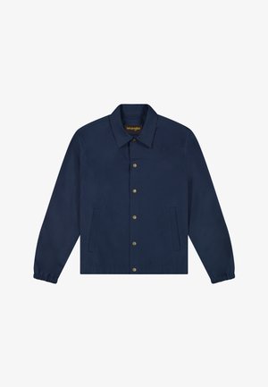 Tumesinis mereväe sinine nööpidega jakk, pikkade varrukatega, elastsete varrukaotsadega, kahe ees taskuga ja terava kraega.