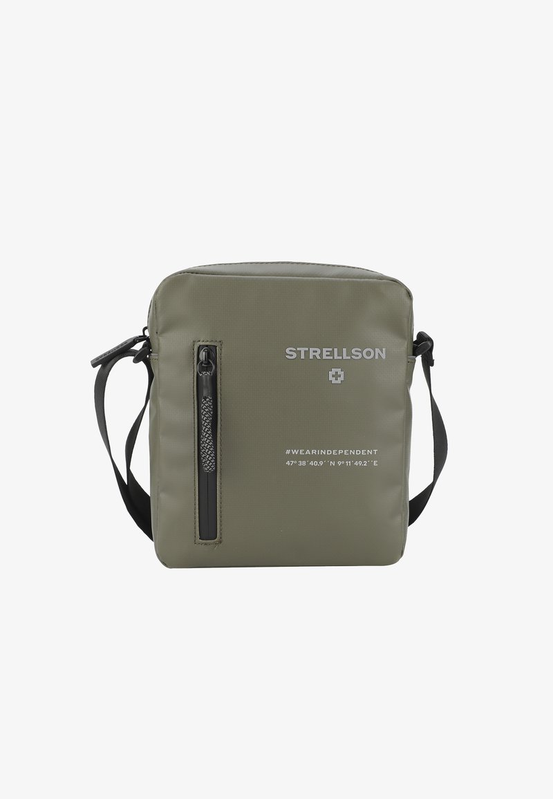 Grøn nylon messenger taske med en frontlomme med lynlås, sorte metaldele og trykt tekst. Den har en justerbar rem for alsidighed.