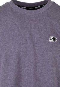 Purple cotton t-shirt with a crew neck and a small black and white embroidered logo on the left chest area. Smooth texture.