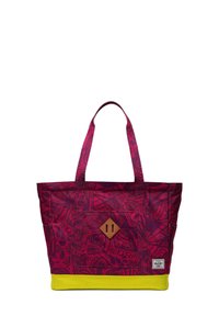 Sac fourre-tout à motifs violets avec une base jaune, comportant deux poignées en tissu et un accent en cuir brun en forme de diamant sur le devant.