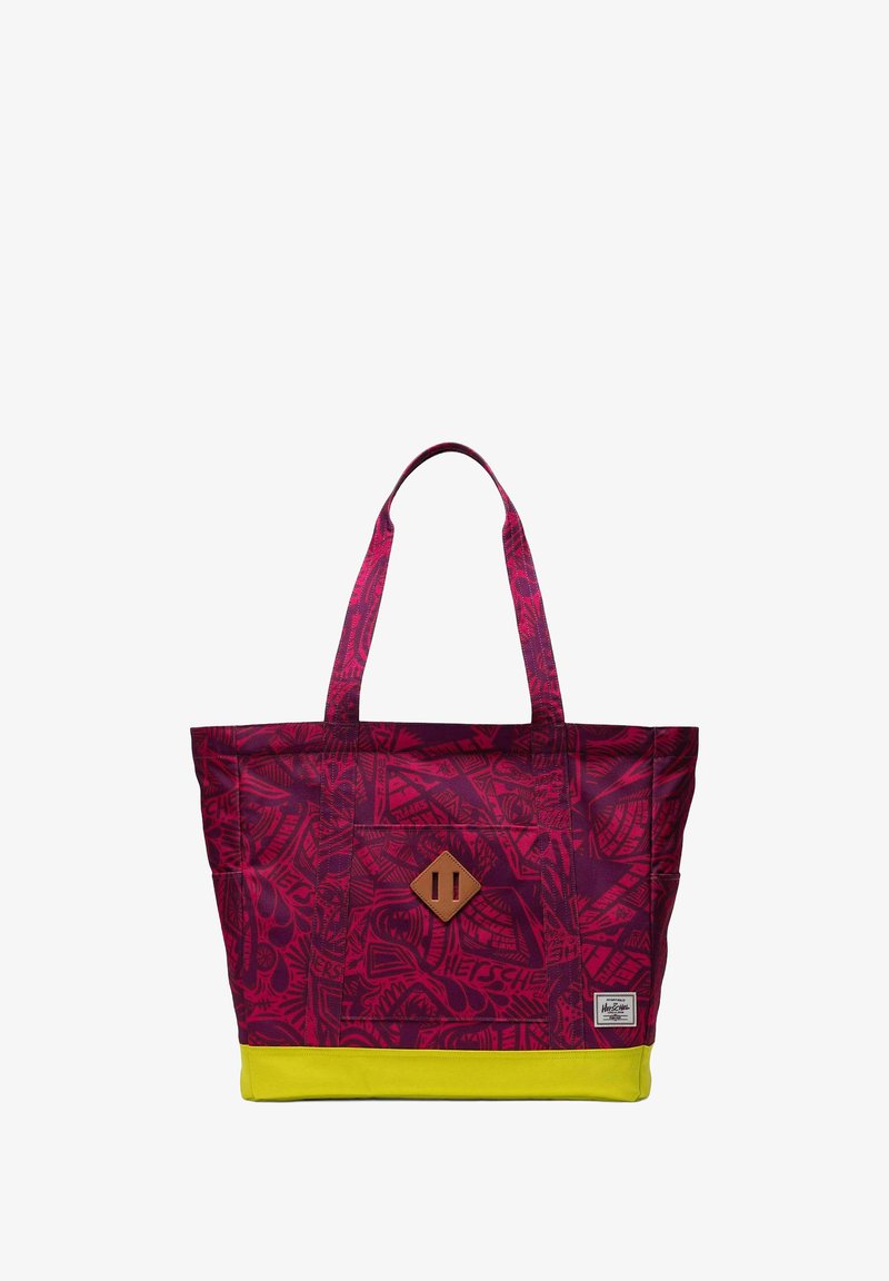 Sac fourre-tout à motifs violets avec une base jaune, comportant deux poignées en tissu et un accent en cuir brun en forme de diamant sur le devant.