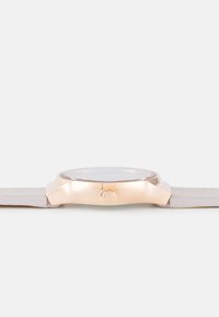 Round watch with a metallic rose gold case, clear glass face, and beige leather strap. Features a single side button for adjustment.