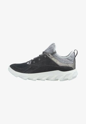 Dark gray athletic shoe with a textured upper, contrasting gray accents, and a white, rugged sole. Features mesh panels and lace-up design.