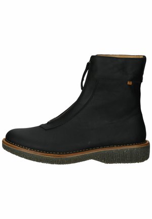Black leather ankle boot with a textured sole, side zipper, and stitched detailing around the edge. Smooth finish with minimal accents.
