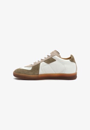 Sneakers crafted from white leather and olive green suede, featuring a gum rubber sole, white laces, and a textured design.