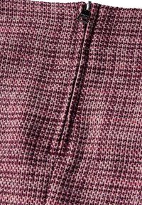 Woven fabric textile in shades of burgundy and pink, featuring a subtle pattern. Includes a vertical zipper closure with metal hardware.