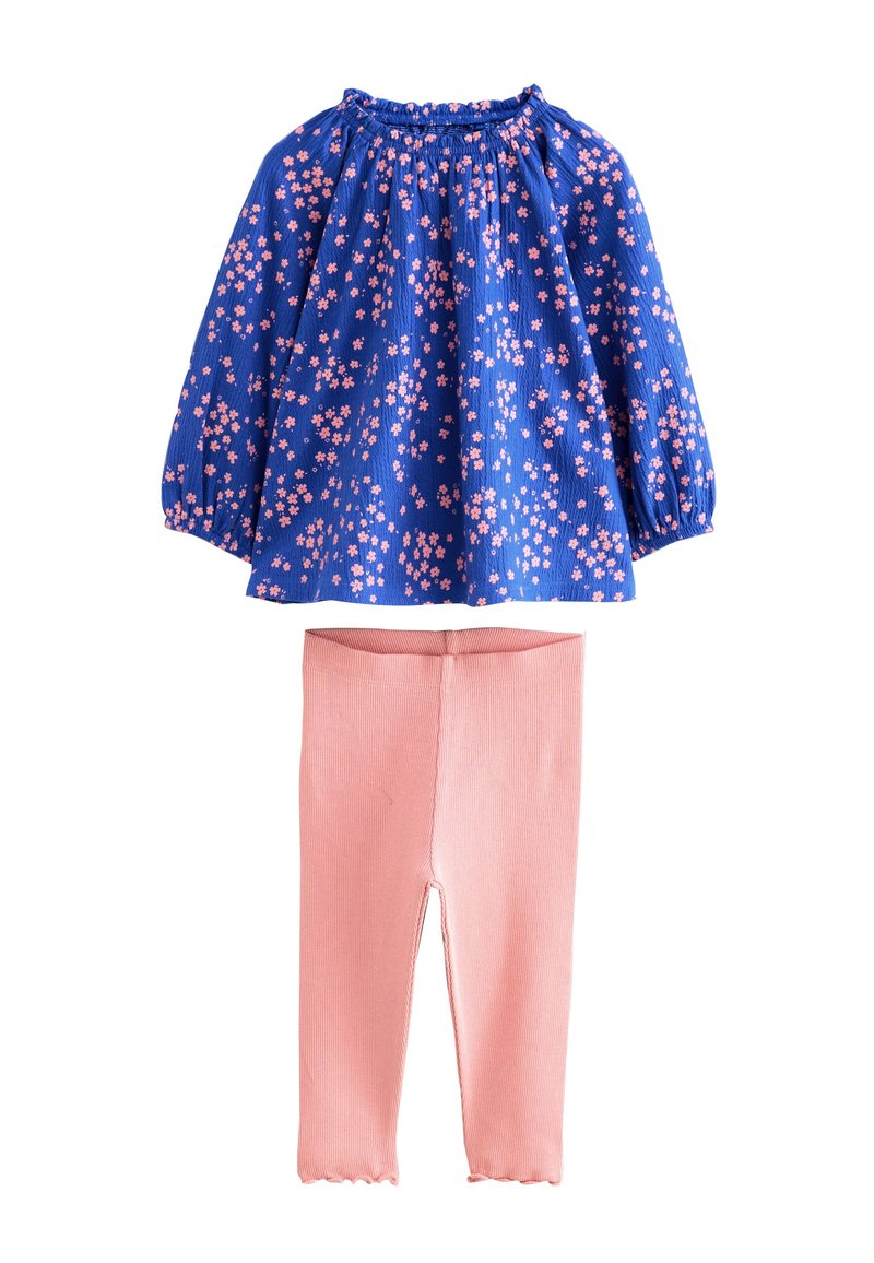 Top a maniche lunghe con stampa floreale blu e fiori rosa, scollo arricciato, abbinato a leggings rosa a costine con orlo smerlato.