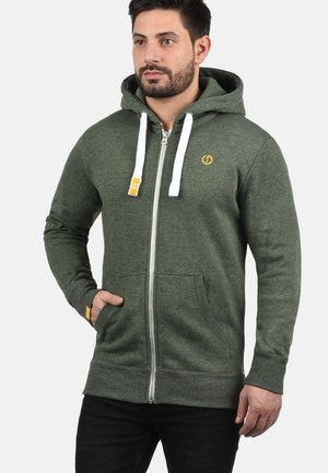 Green zip-up hoodie made of soft fabric with a front pocket, white drawstrings, and a small yellow logo on the chest.