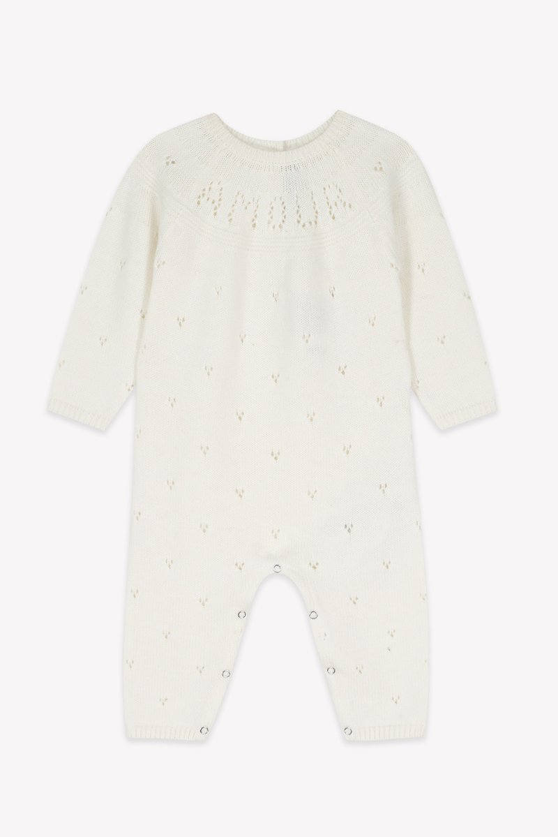 White knitted romper with long sleeves, textured pattern, and tiny heart motifs. Features snap closures at the bottom for easy dressing.