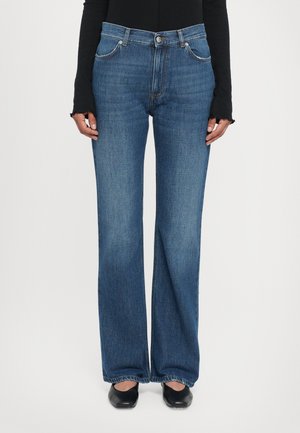 Wide-leg jeans made of denim, featuring a dark blue color, classic five-pocket design, visible stitching, and a button closure at the waist.