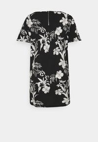 Robe noire à manches courtes avec imprimé floral tropical blanc et une fermeture éclair argentée visible sur le haut du dos.